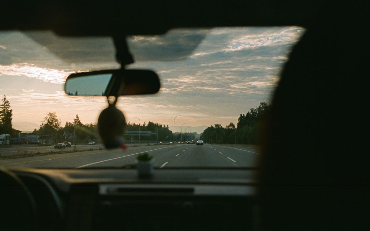Road trip view through the windshield at sunset