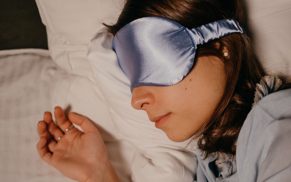 Traveller sleeping with a soft eye mask